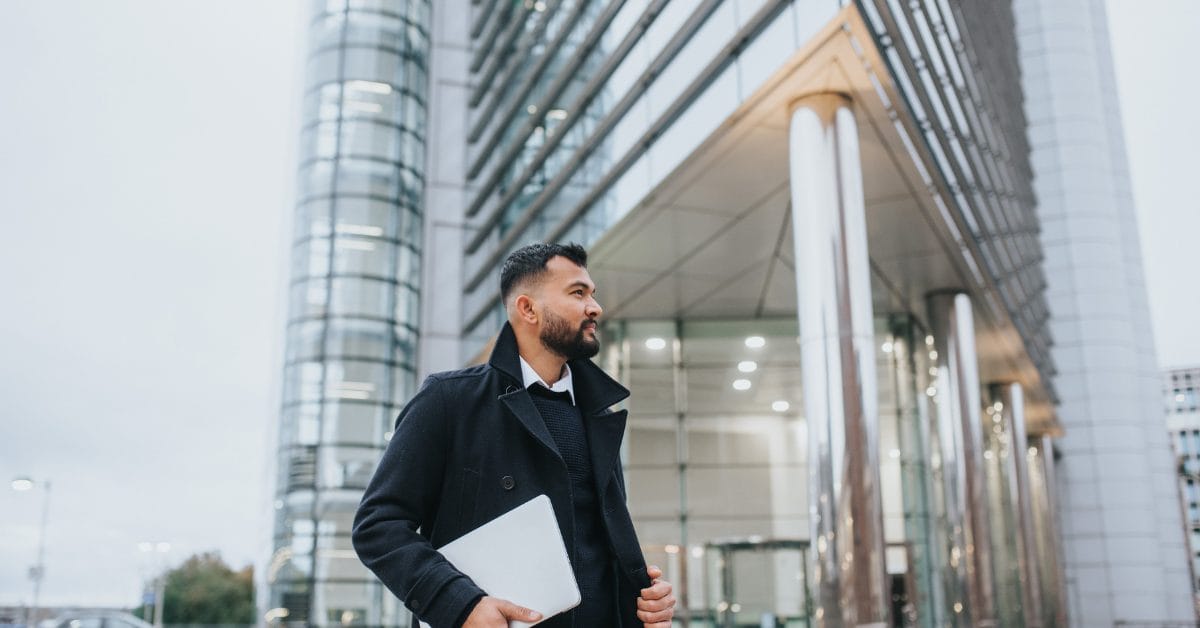 Entrepreneur walking downtown in front of commercial building on the phone