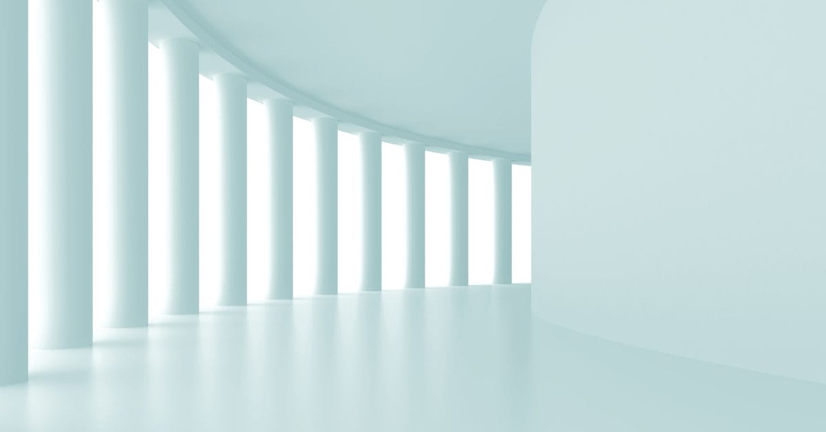 white architecture pillars in long hallway