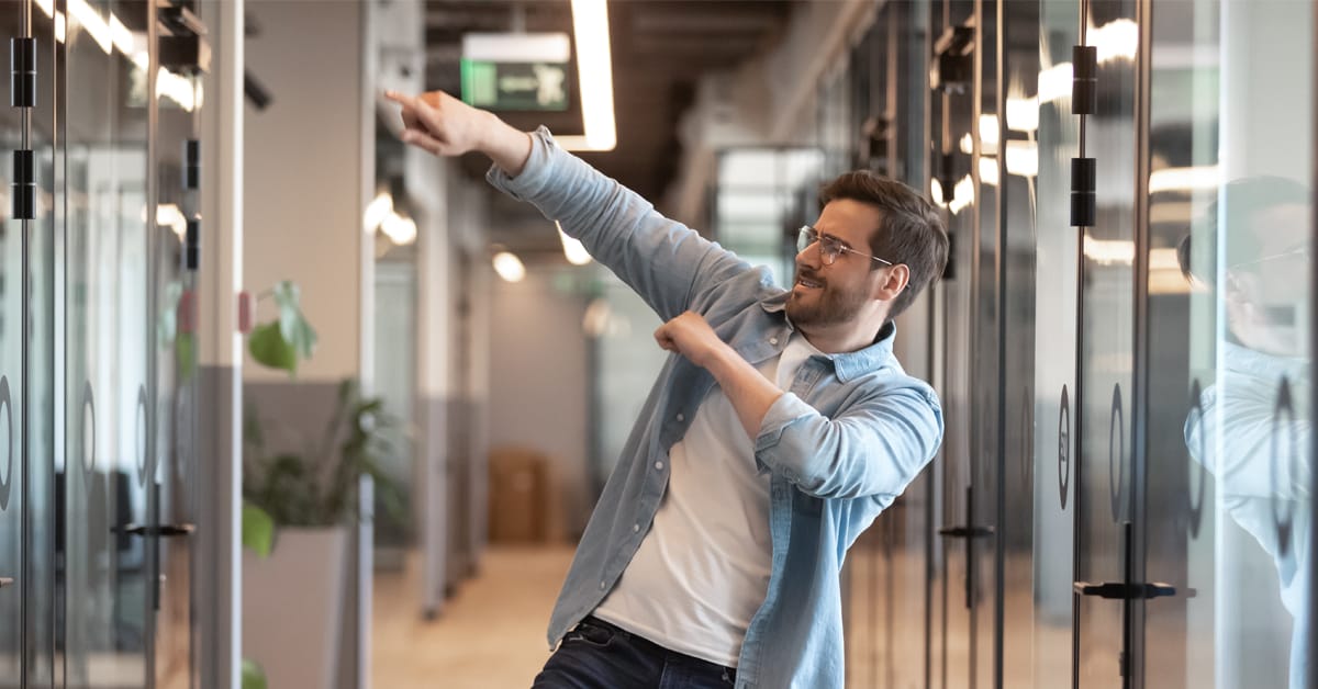 Happy motivated male employee cheering with excitement after receiving a reward
