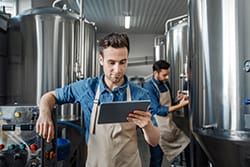 Small business owner reviewing data on his tablet