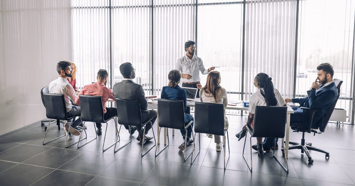 senior professional holding a mentoring class in a modern conference room