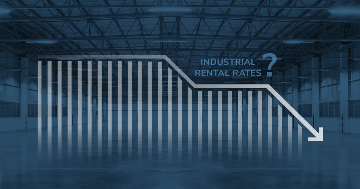 vacant industrial warehouse with downward trend rental rate graph overlay