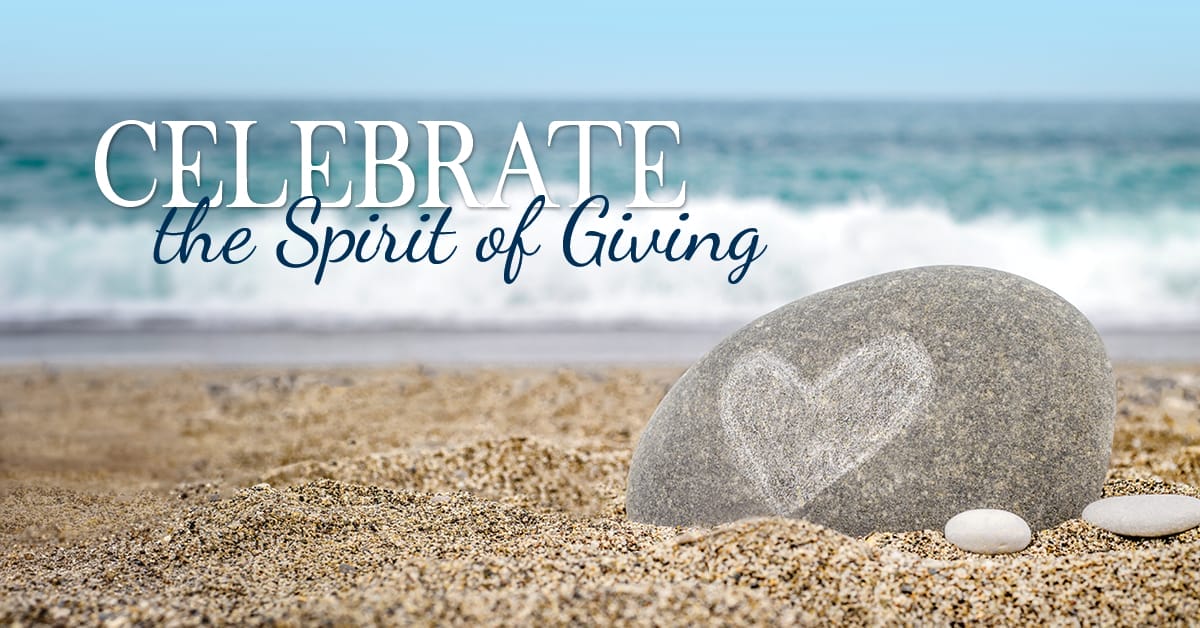 Celebrate the Spirit of Giving overlayed on a beach photo with a heart on a rock