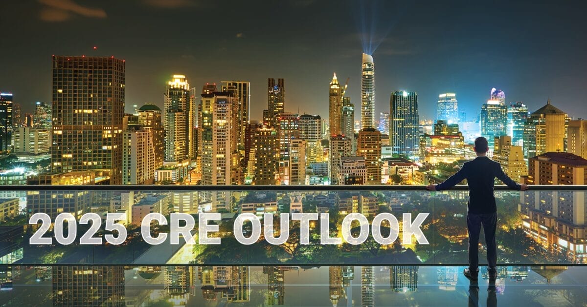 2025 CRE Outlook Man looking out over a city skyline at night