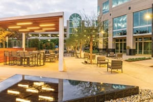 Office buiding exterior patio seating with television and fountain